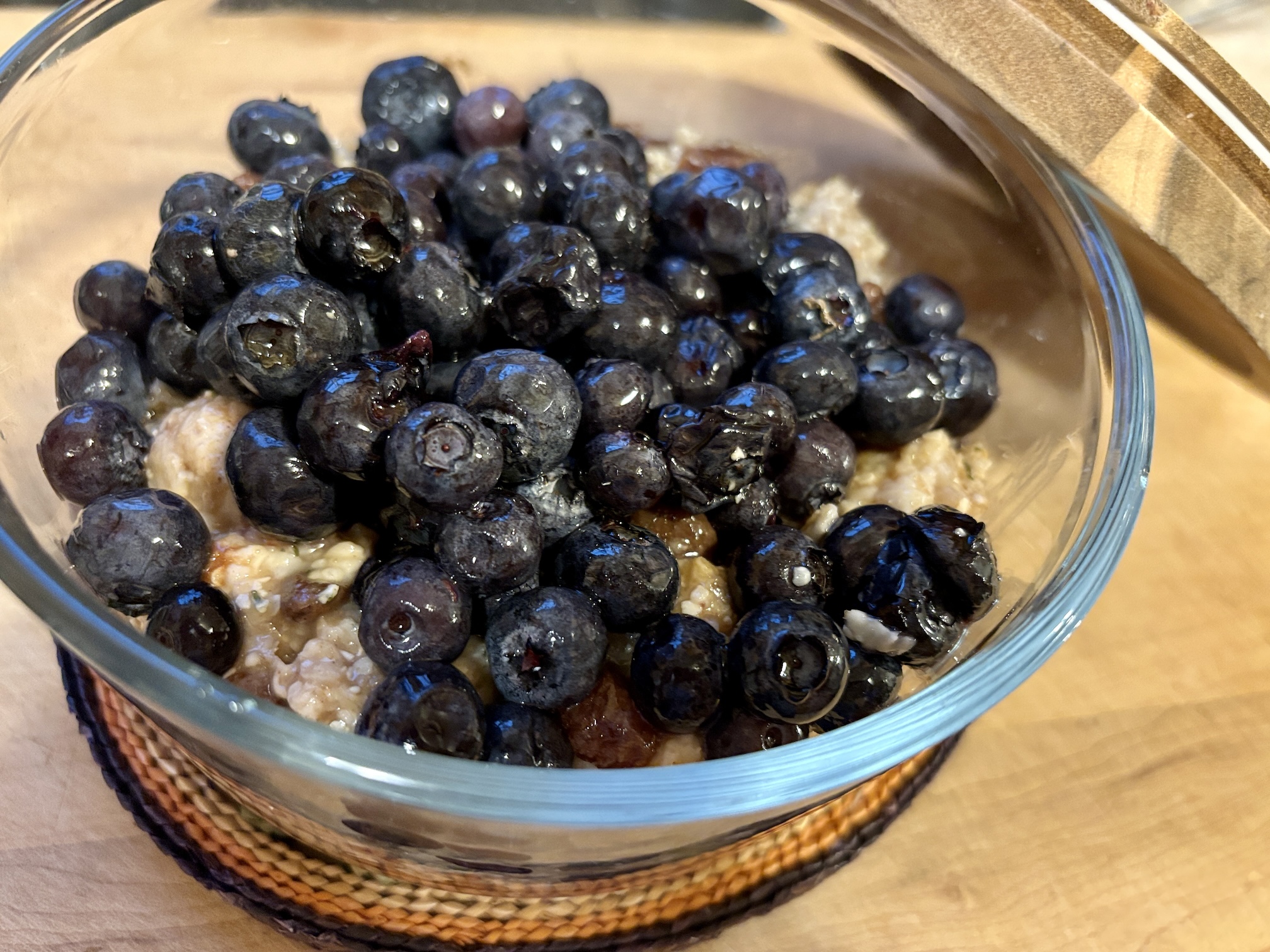 Breakfast Overnight Oats topped with soy milk and blueberries in a to-go bowl Breakfast Overnight Oats topped with soy milk and blueberries in a to-go bowl
