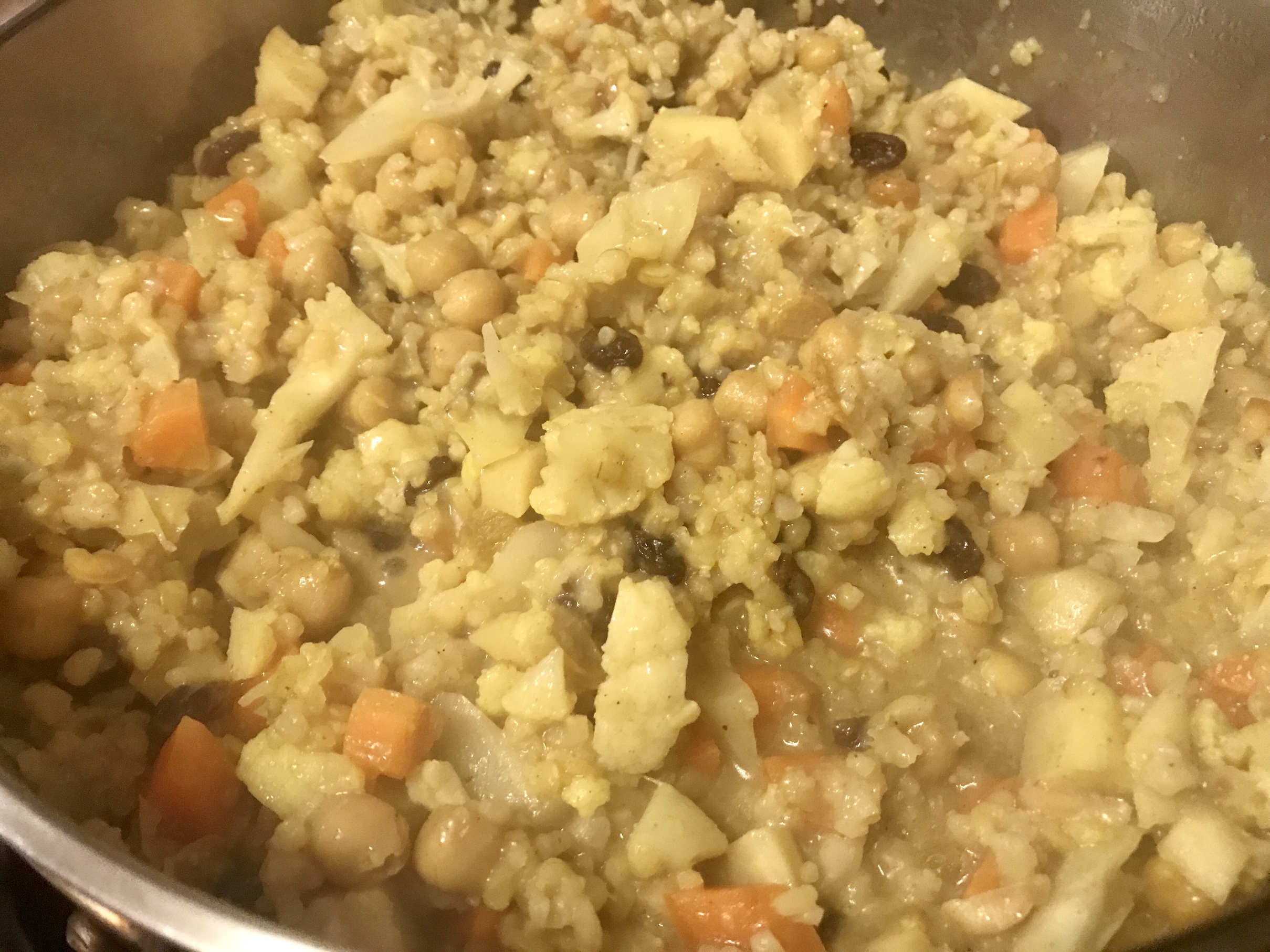 Brown Rice Refried with Vegetables & Raisins cooking in pan