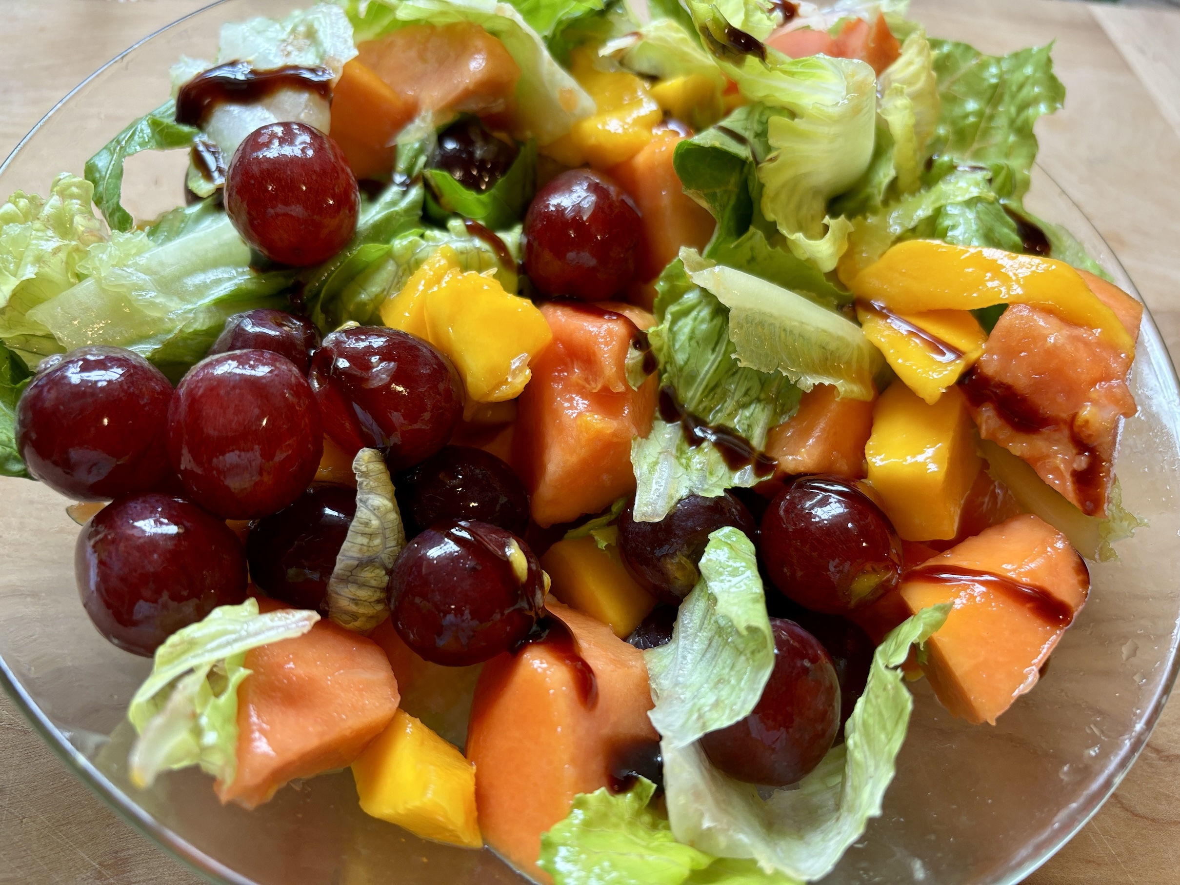 Breakfast Fruit Salad of Papaya, Mango, Grapes and Romaine Lettuce Breakfast Fruit Salad of Papaya, Mango, Grapes and Romaine Lettuce