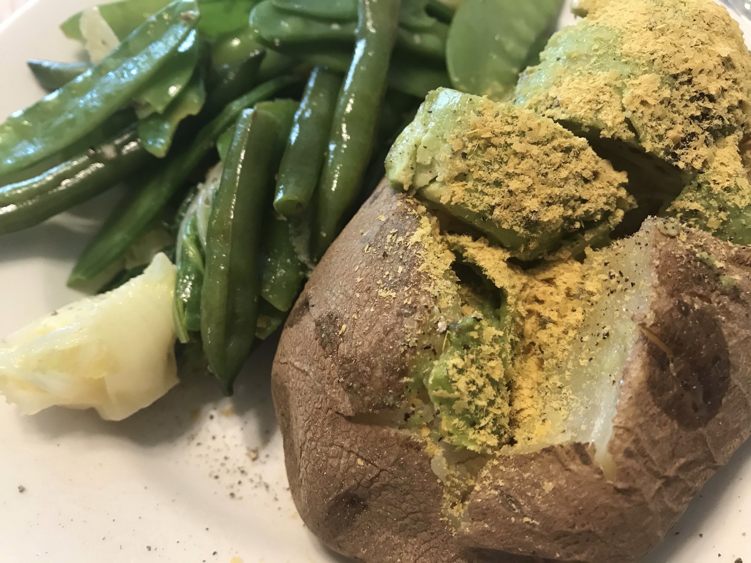 Potato, Baked Russet topped with nutritional yeast, along with green beans & pea pods