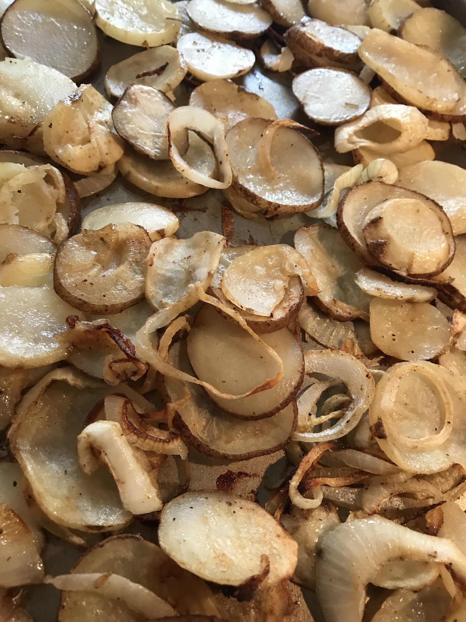 Potatoes sliced thin, and roasted with onions Potatoes sliced thin, and roasted with onions