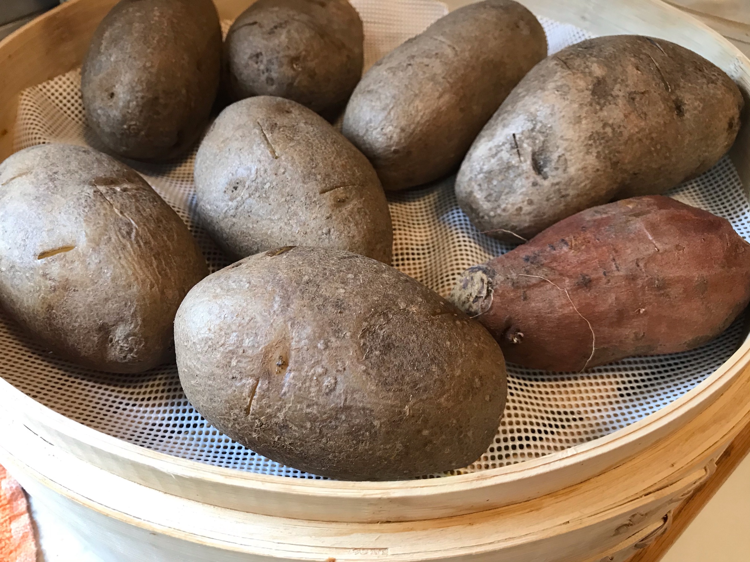 Potatoes in bamboo steamer