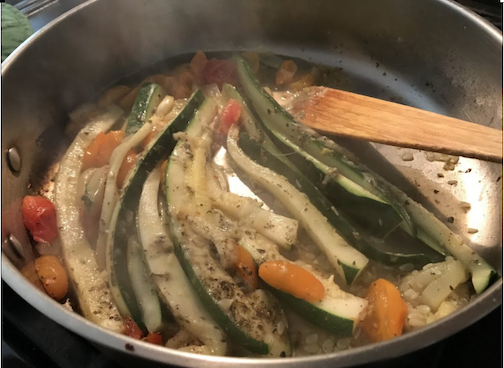 Italian Zucchini and Tomato cooking in pan