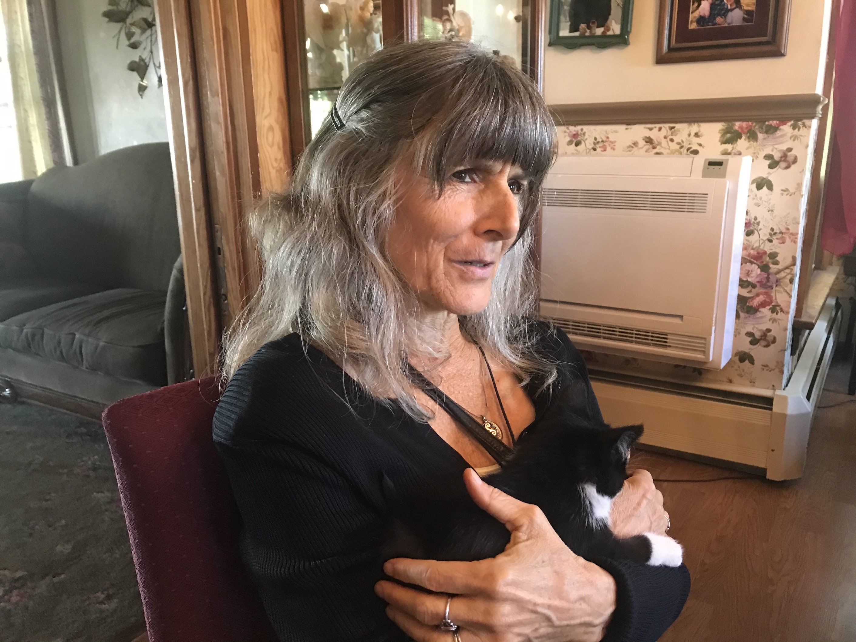 Me holding adorable black and white kitten at a family gathering